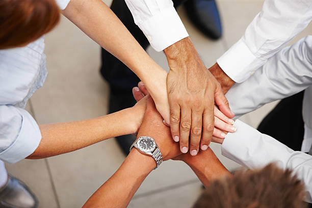 High angle view of business colleagues showing unity